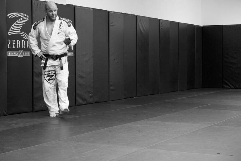 Greg Kalteich, Owner and Head Instructor at Fight For Us Jiu Jitsu, in his gi and black belt on the mat